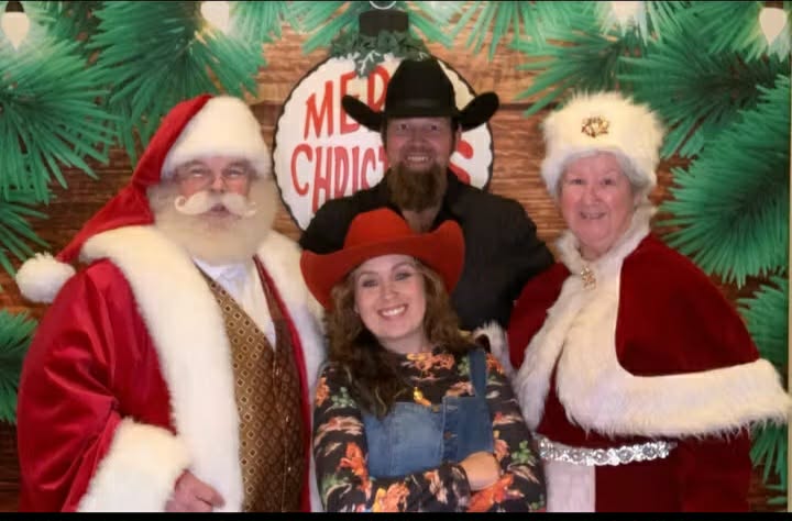 Santa and Mrs Claus with cowboy family